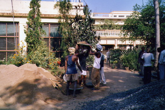 Moving sand to rear of new block Moving sand to rear of new block
